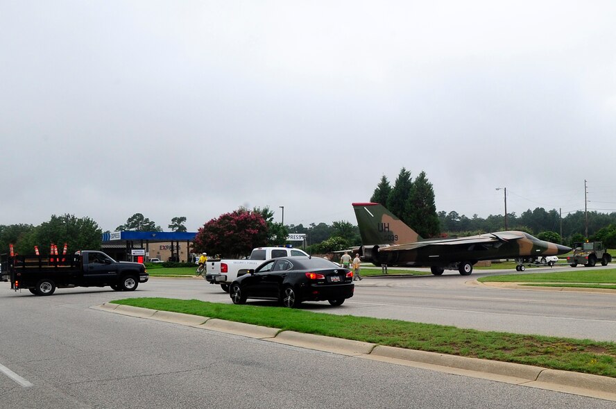 Team Shaw members guide the F-111 Aardvark static display across Perimeter Road at Shaw Air Force Base, S.C., Aug. 12, 2012. This particular F-111 Aardvark was assigned to the 20th Fighter Wing when the unit was originally located in England. (U.S. Air Force photo by Airman 1st Class Hunter Brady/Released)