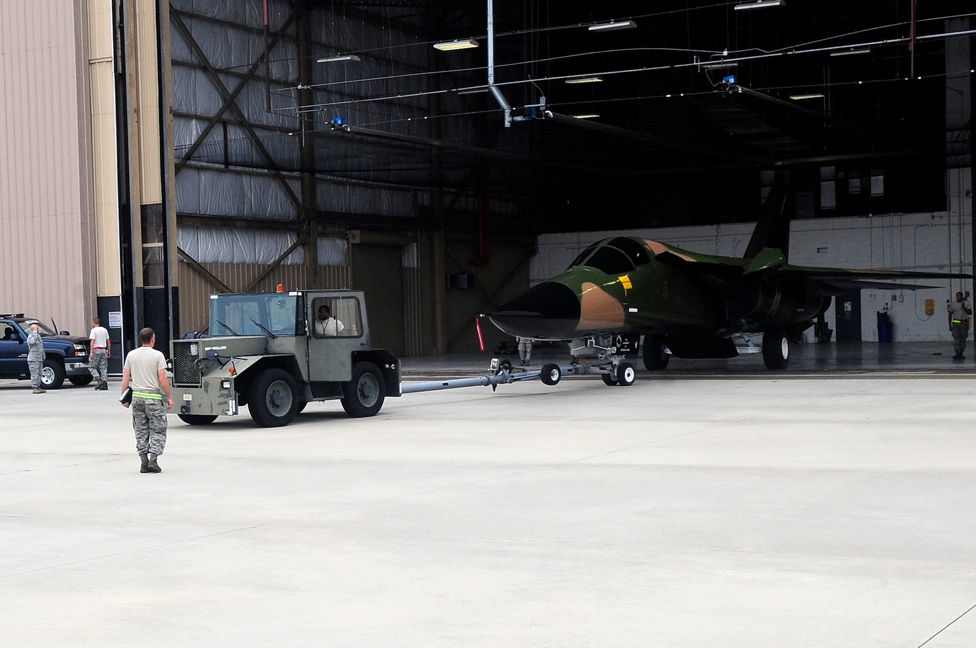 Members of Team Shaw begin to move the F-111 Aardvark static display out of Hanger 1200 at Shaw Air Force Base, S.C., Aug. 12, 2012. This particular F-111 Aardvark was assigned to the 20th Fighter Wing when the unit was originally located in England. (U.S. Air Force photo by Airman 1st Class Hunter Brady/Released)