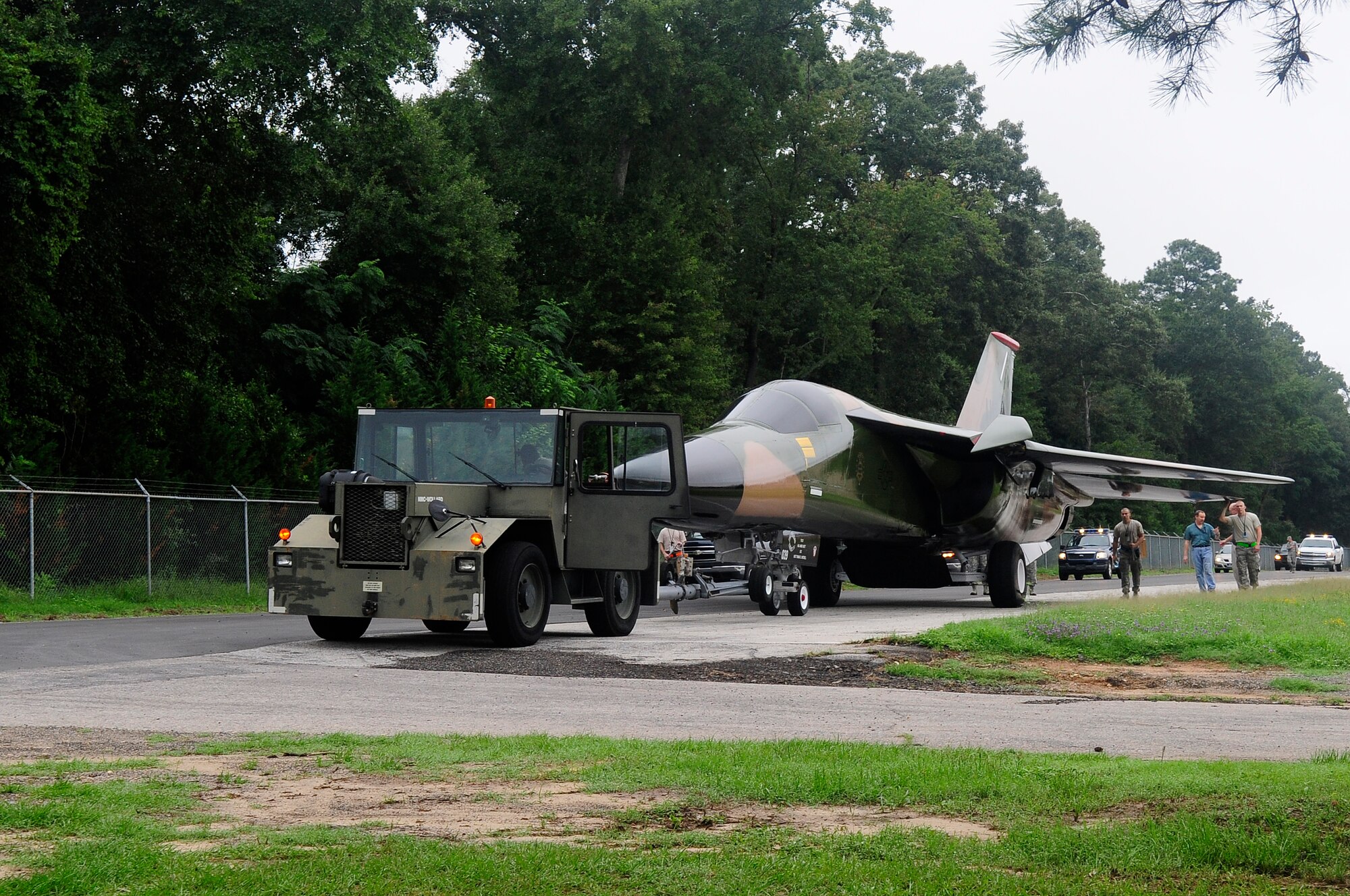 The F-111 Aardvark static display travels down Aiken Street accompanied by Team Shaw members at Shaw Air Force Base, S.C., Aug. 12, 2012. This particular F-111 Aardvark was assigned to the 20th Fighter Wing when the unit was originally located in England. (U.S. Air Force photo by Airman 1st Class Hunter Brady/Released)