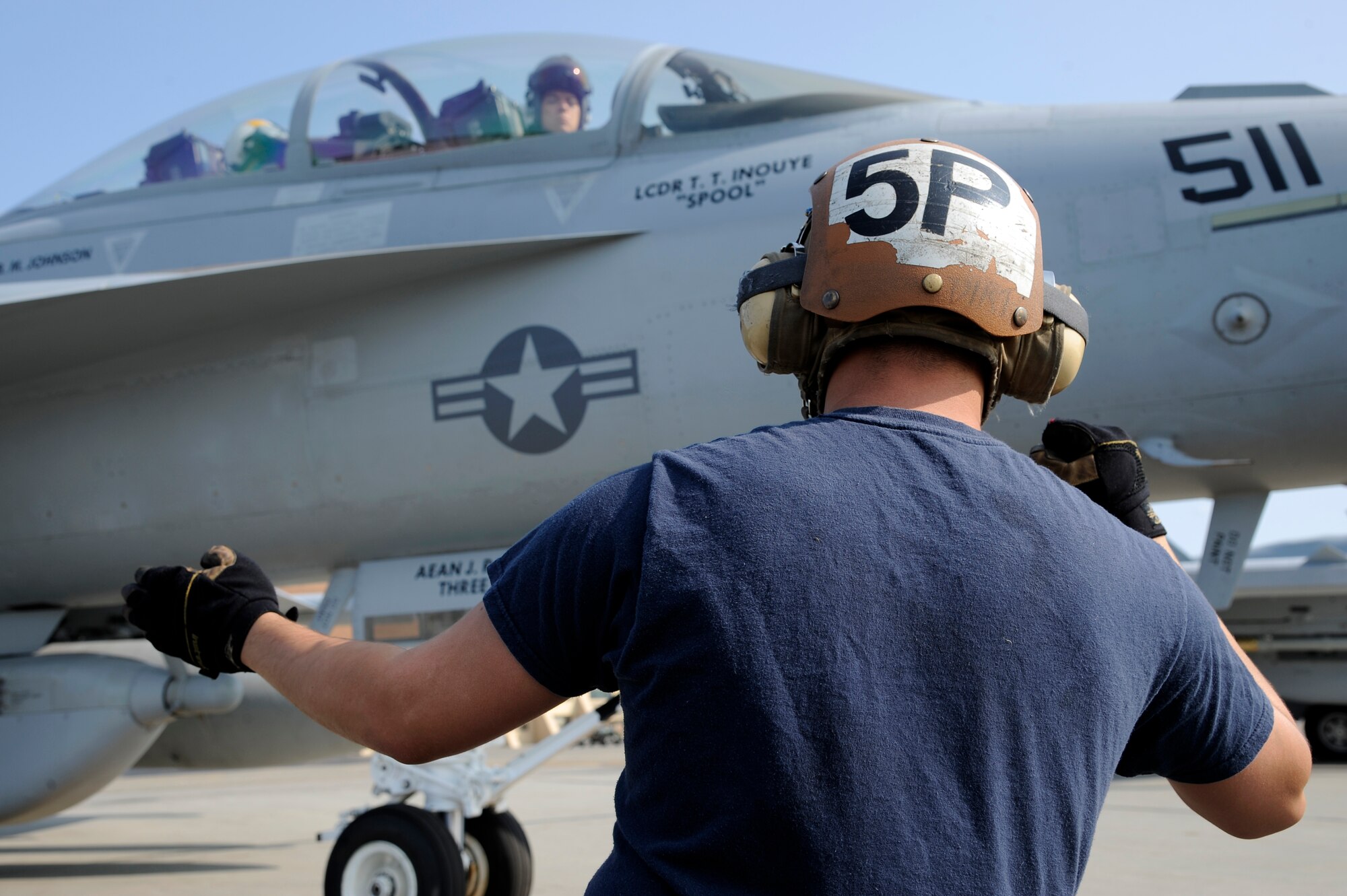 A U.S. Navy sailor assigned to the Electric Attack Squadron 138th from Naval Air Station Whidbey Island, Wash., performs preflight checks on an EA-18G Growler prior to take off during RED FLAG-Alaska 12-3 Aug. 10, 2012, Eielson Air Force Base, Alaska.  (U.S. Air Force photo/Staff Sgt. Jim Araos)