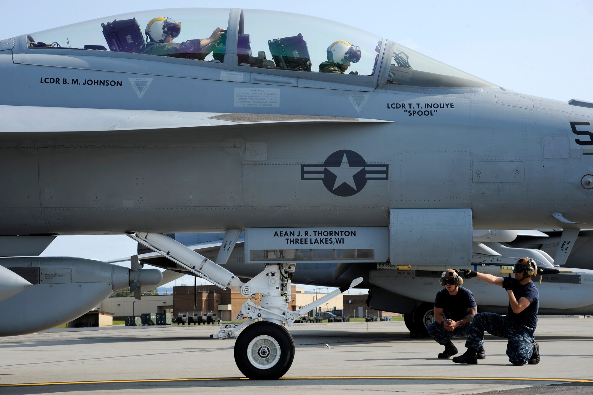 U.S. Navy sailors assigned to the Electric Attack Squadron 138th from Naval Air Station Whidbey Island, Wash., perform preflight checks on an EA-18G Growler prior to take off during RED FLAG-Alaska 12-3 Aug. 10, 2012, Eielson Air Force Base, Alaska. The goal of the exercise is to train not only pilots, but every member of the team to operate, survive and win.  (U.S. Air Force photo/Staff Sgt. Jim Araos)