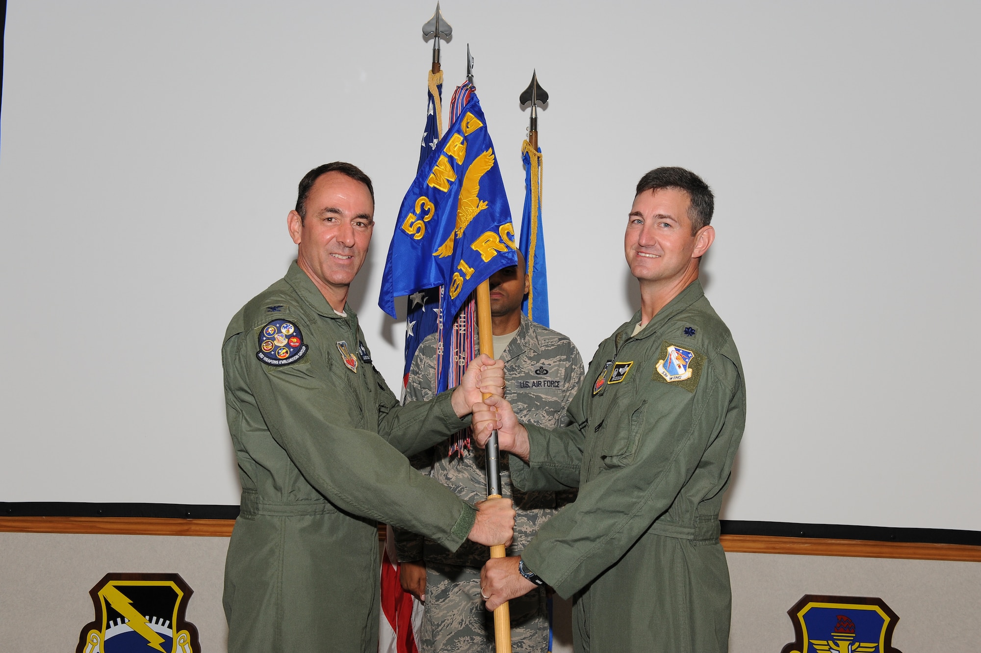 Colonel James R. Vogel, 53rd Weapons Evaluation Group commander, passes the 81st Range Control Squadron guidon to Lt. Col. Bruce Bunce, who assumed command of the 81st RCS in a change of command ceremony Aug. 10. (U.S. Air Force photo by Lisa Norman) 