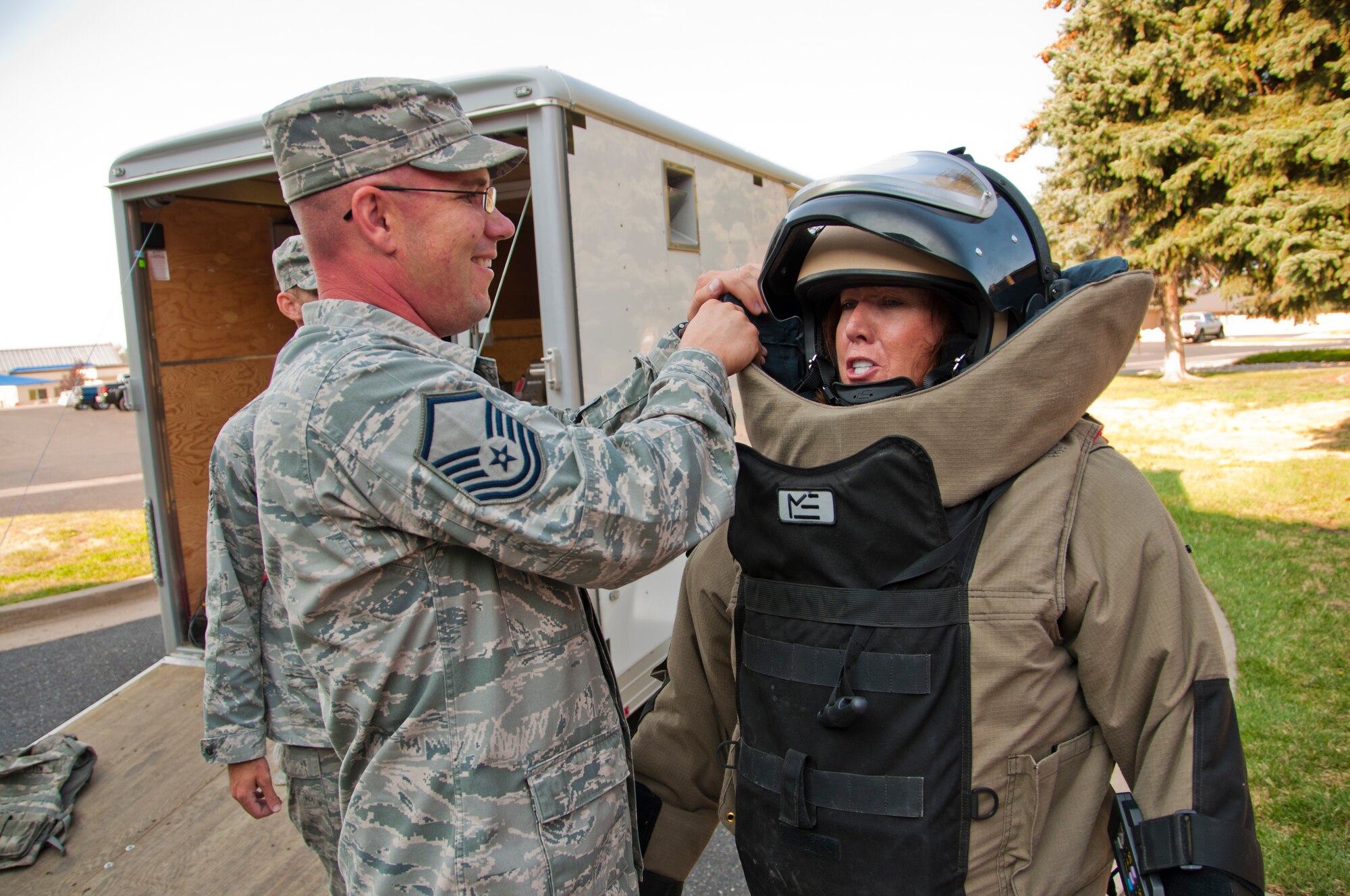 Elaine Vreeland, a manager with the University of Phoenix, tries on a 75-pound EOD bomb suit and did three push-ups while wearing the gear. “I’m so impressed with this group, and I’m very grateful that they’re protecting us,” Vreeland said. “I’m grateful for the sacrifice they make and the sacrifice their families make.” (U.S. Air Force photo/Senior Airman Crystal Charriere)