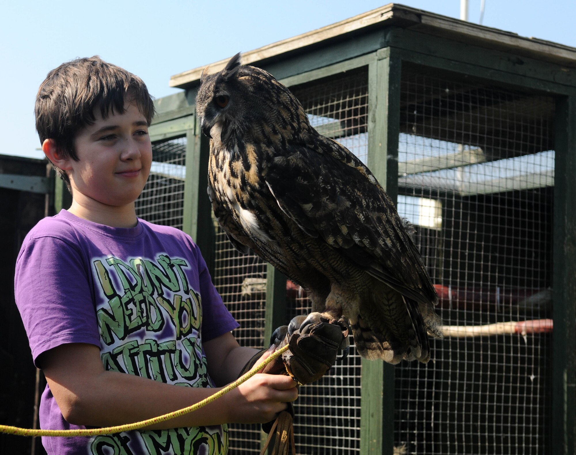 RAF MILDENHALL, England – Callum Ewing, 12, holds an eagle owl at the Phoenix Bird Control’s facility here Aug. 10, 2012. The visit was part of a tour designed to allow Ewing, his mother and sister to get a glimpse into the working life of their late father, who was a Ministry of Defence Police sergeant stationed at RAF Mildenhall, before he passed away from a heart attack in 2008. Family friend and fellow MoD Police Sergeant Chris Fisher arranged the visit. (U.S. Air Force photo/Staff Sgt. Austin M. May)
