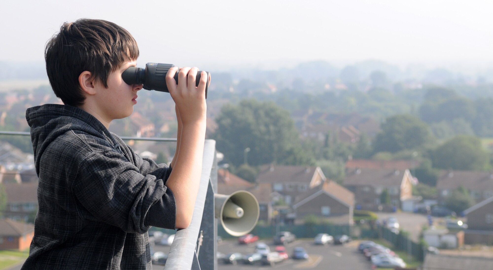 RAF MILDENHALL, England – Callum Ewing, 12, adjusts a pair of binoculars during a tour of the air traffic control tower here Aug. 10, 2012. In addition to the tower, the Ewing family was able to visit the KC-135 Stratotanker flight simulator and Phoenix Bird Control’s facility. The tour was to allow Ewing, his mother and sister to get a glimpse into the life of their late father, who was a Ministry of Defence Police sergeant stationed at RAF Mildenhall, before he passed away from a heart attack in 2008. (U.S. Air Force photo/Staff Sgt. Austin M. May)