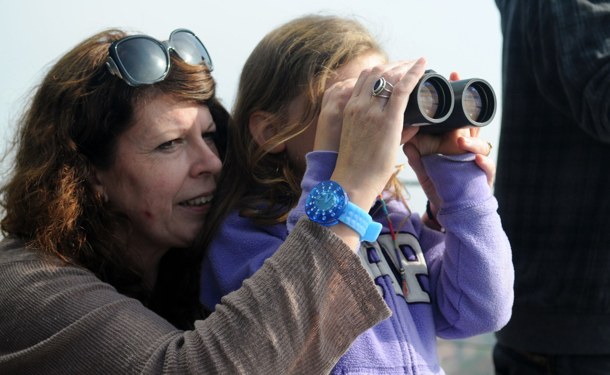 RAF MILDENHALL, England – Isobel Ewing helps her daughter Denna, 6, adjust a pair of binoculars during a tour of the air traffic control tower here Aug. 10, 2012. The tour was to allow Ewing’s two children to get a glimpse into the working life of their late father, who was a Ministry of Defence Police sergeant stationed at RAF Mildenhall. Sgt. Jimmy Ewing passed away from a heart attack in 2008. (U.S. Air Force photo/Staff Sgt. Austin M. May)