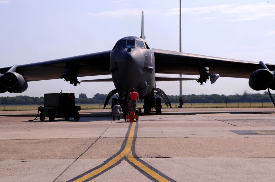 Airmen 1st Class Robert Knife and Jeremy Locke, 96th Bomb Squadron crew chiefs, prepare a B-52H Stratofortress for take-off in support of exercise Combat Hammer on Barksdale Air Force Base, La., Aug. 13. The exercise evaluates the employment of precision-guided munitions, assesses combat capabilities and improves PGM performance. The munitions will be flown to a test range in Utah where they will be dropped. The 2nd Bomb Wing will be launching eight B-52H Stratofortress Bombers during phase two of the exercise. (U.S. Air Force photo/Senior Airman La'Shanette V. Garrett)(RELEASED)