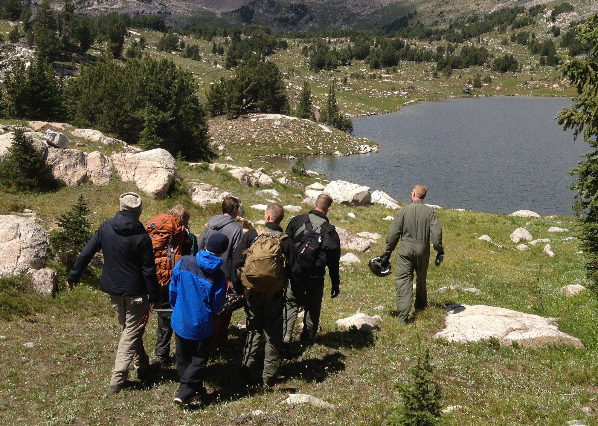 Members of the 40th Helicopter Squadron along with other hikers transfer a 14-year-old boy to the on-sight aircraft for transportation to a hospital Aug. 3. The boy was suspected to have developed life-threatening appendicitis and needed to be extracted via helicopter to get medical attention. (U.S. Air Force photo/Capt. Erik Greendyke)