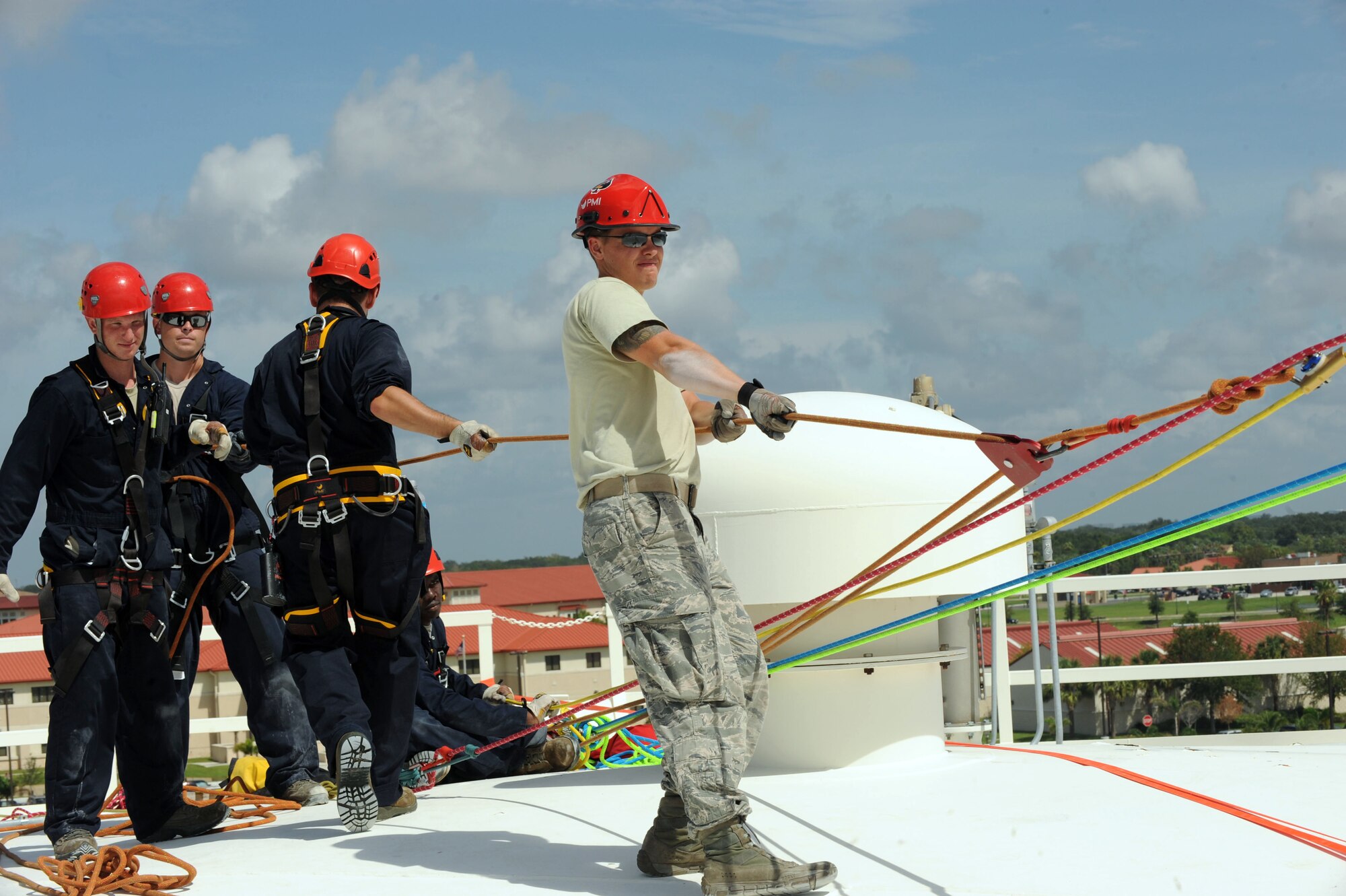 Airmen prepare the lines used to rappel in between two fuel tanks Aug. 6, 2012, MacDill Air Force Base, Fla. Civil engineer firefighters were instructed on rope rescue, surface water rescue, high angle rescue and confined space rescue during a three-week course. 
(U.S. Air Force photo/Senior Airman Rachelle Coleman)
