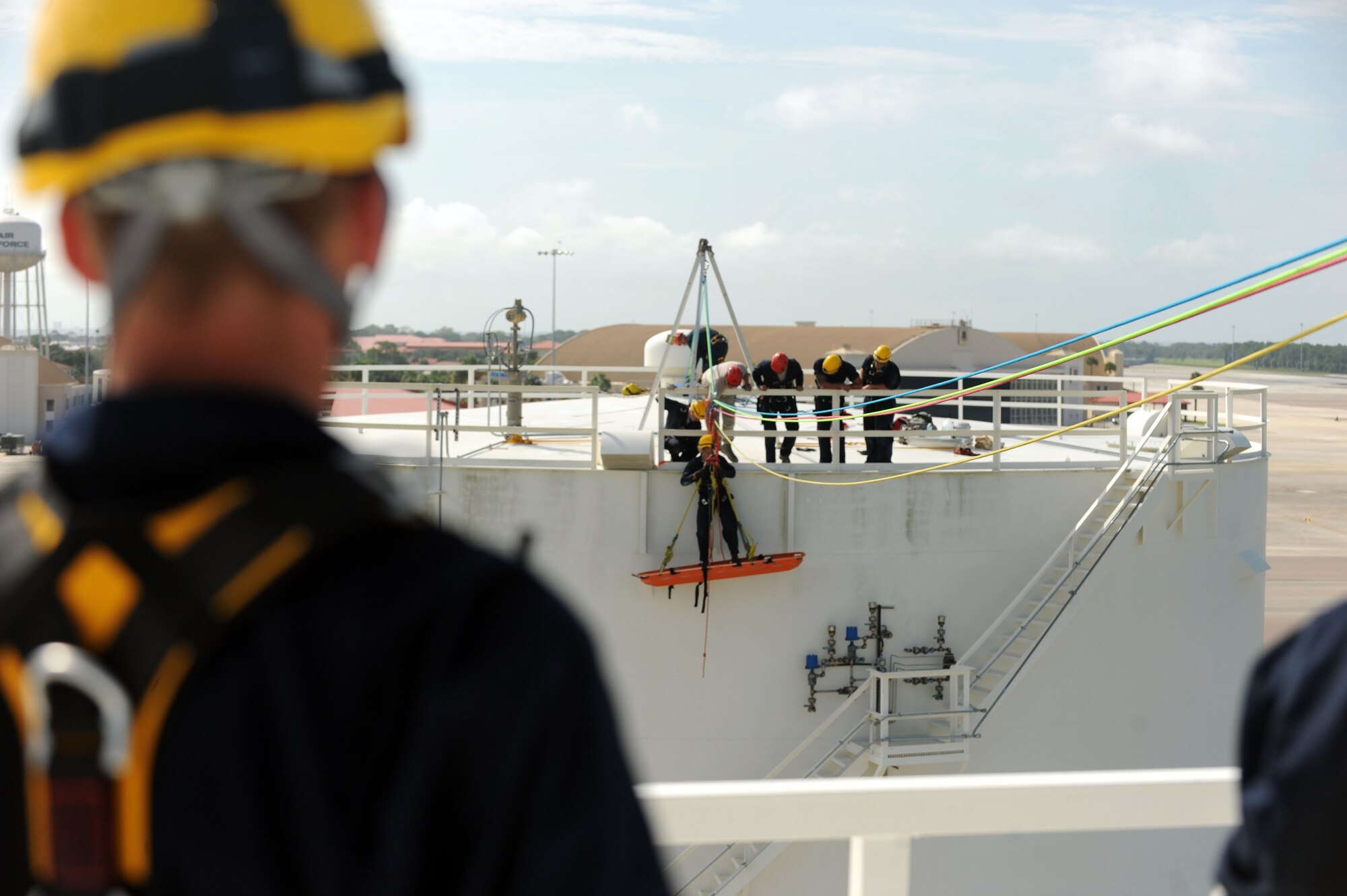 Staff Sgt. Neal Krysinski, 6th Civil Engineer Squadron firefighter, watches as Airman 1st Class Jesse Flagle, 45th Civil Engineer Squadron firefighter, is lowered during a high-angle rescue exercise Aug. 6, 2012, MacDill Air Force Base, Florida. Two instructors from the U.S. Air Forces in Europe Fire Academy held the three-week Rescue Technician I course. (U.S. Air Force photo/Senior Airman Rachelle Coleman)