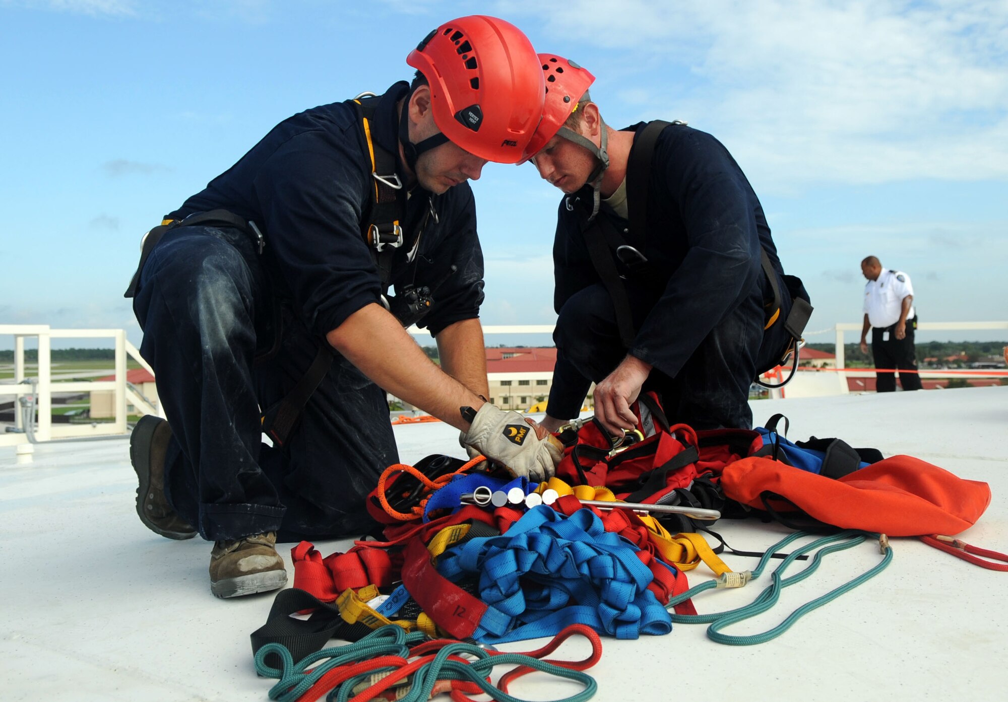 Staff Sgt. Nicholas Smallwood and Senior Airman Daniel Wool, 6th Civil Engineer Sqadron firefighters, prepare ropes and other equipment for a high angle rescue scenario Aug. 6, 2012, at MacDill Air Force Base, Fla. Twelve firefighters graduated from the Rescue Technician I course which included a block of training in rappelling, high- and low- angle rescue. (U.S. Air Force photo/Senior Airman Rachelle Coleman)