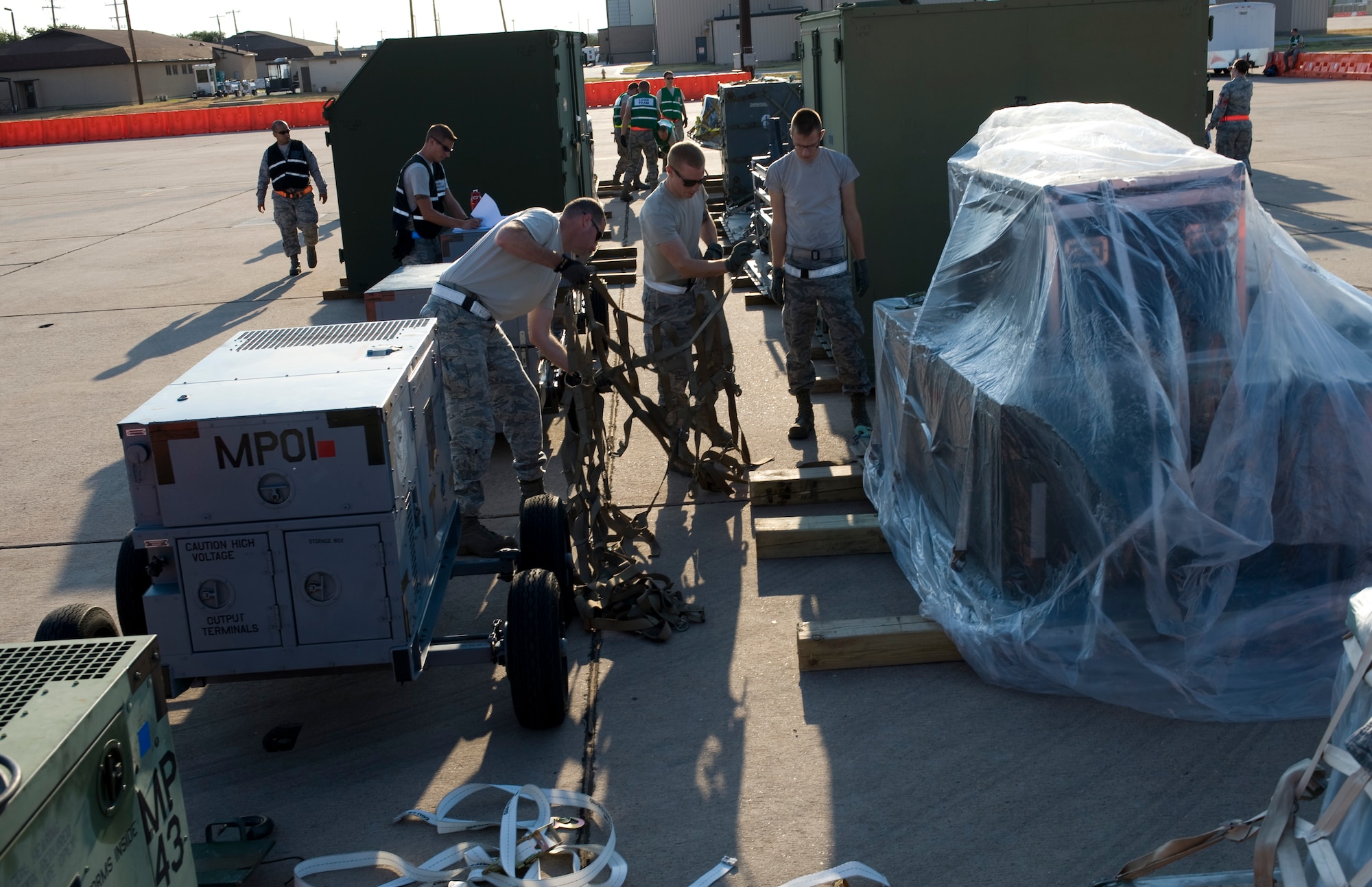 Dyess Airmen place a cargo net on a cargo pallet during an Operational Readiness Exercise Aug. 10, 2012, at Dyess Air Force Base, Texas. Processing cargo quickly and accurately is a vital part of getting the equipment where it needs to be. Airmen from the 7th Bomb Wing ensure cargo is weighed properly, secured and safe before it is loaded onto an aircraft. (U.S. Air Force photo by Staff Sgt. Richard P. Ebensberger/ Released)