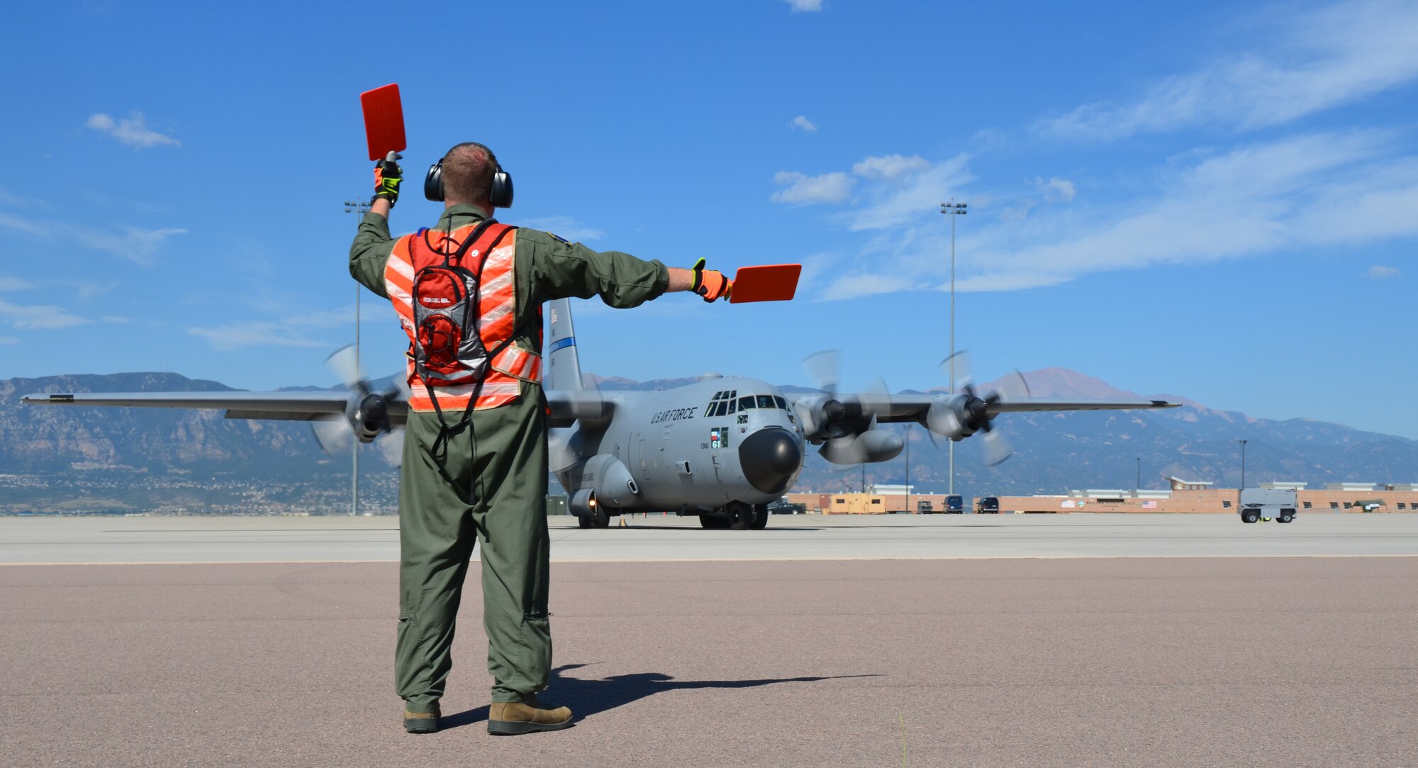 TSgt. Steve Duplessis, 439th Airlift Control Flight (ALCF) Loadmaster, marshals a C-130 to the runway in Colorado Springs, Aug. 11, 2012. Five ALCF units reserve-wide participated in an annual Air Force Reserve exercise where Airmen operated two contingency response exercises, one in Colorado Springs and another in Pueblo, Colo., with C-17 and C-130's flying between the two locations. (U.S. Air Force photo by SrA. Kelly Galloway)