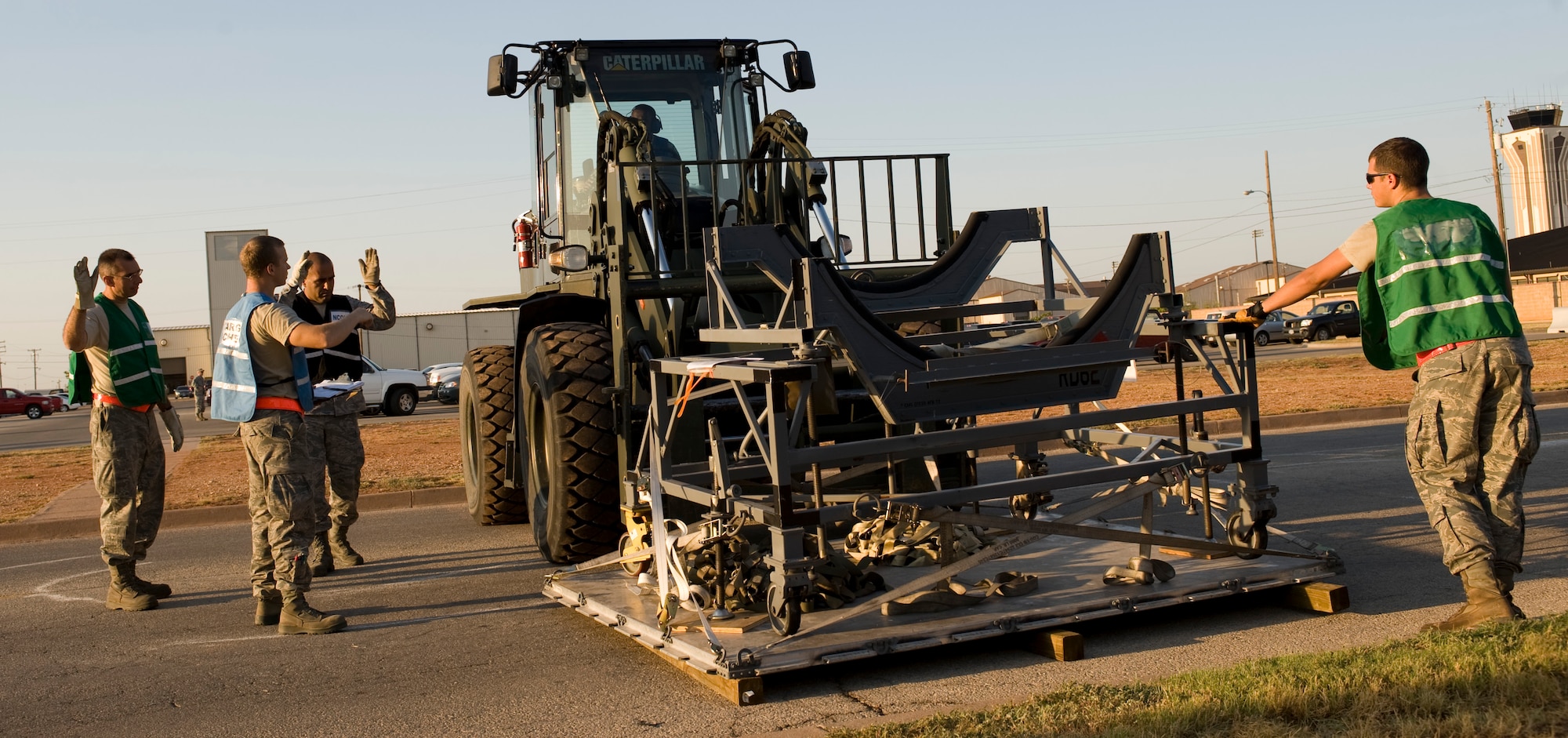 Dyess Airmen move a cargo pallet during an Operational Readiness Exercise Aug. 10, 2012, at Dyess Air Force Base, Texas. Processing cargo quickly and accurately is a vital part of getting the equipment where it needs to be. Airmen from the 7th Bomb Wing ensure cargo is weighed properly, secured and safe before it is loaded onto an aircraft. (U.S. Air Force photo by Staff Sgt. Richard P. Ebensberger/ Released)