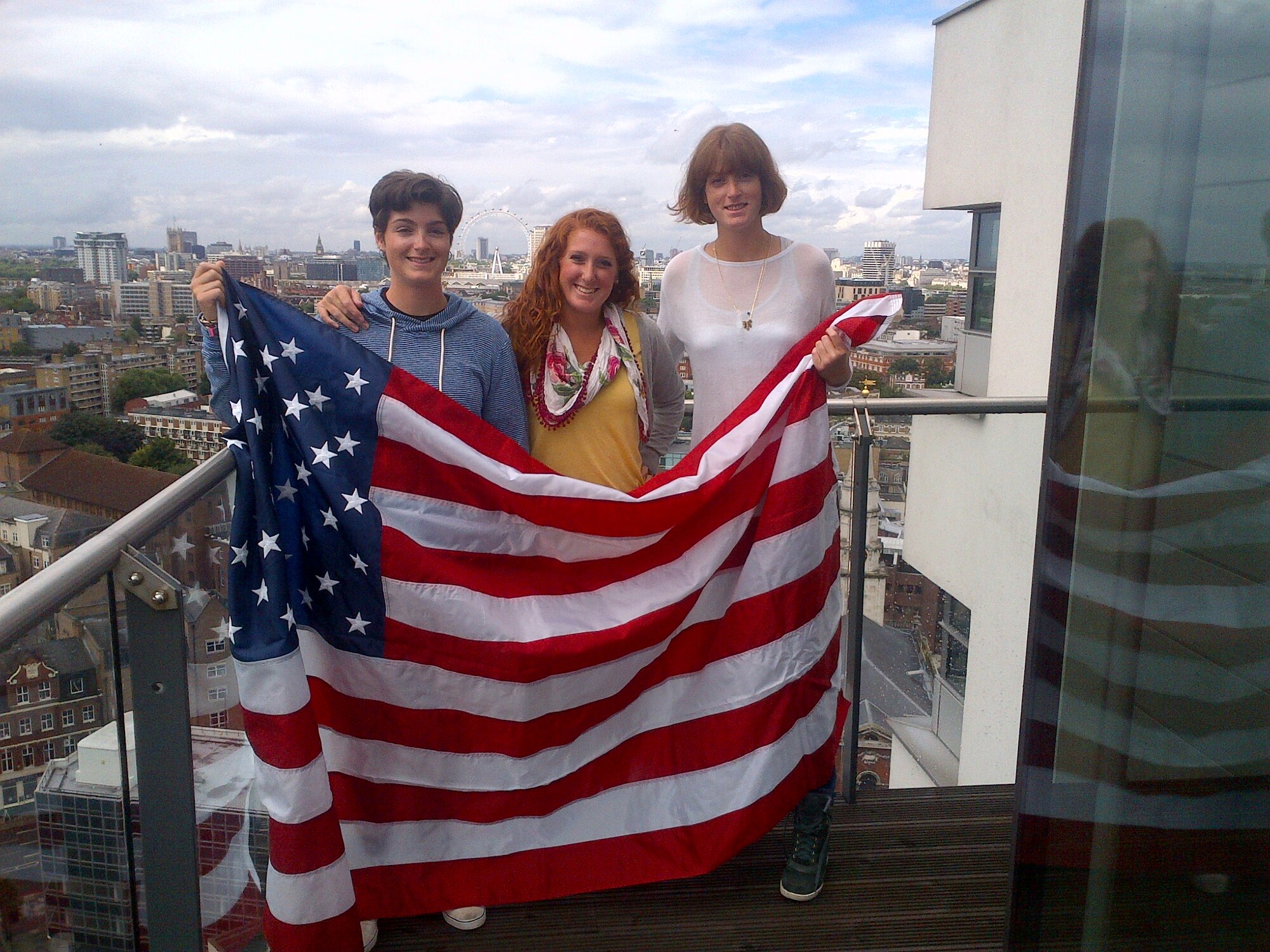 From left, Ciar, Eimile and Caitlin Colgan, daughters of former Olympic rower and American300 guest speaker Sean Colgan, hold an American flag once flown over a Missile Alert Facility at Minot Air Force Base, N.D. The 91st Missile Wing gave the flag to Colgan. Ciar, Eimile and Caitlin, were in London with their father during the Olympics. (Photo by Sean Colgan)