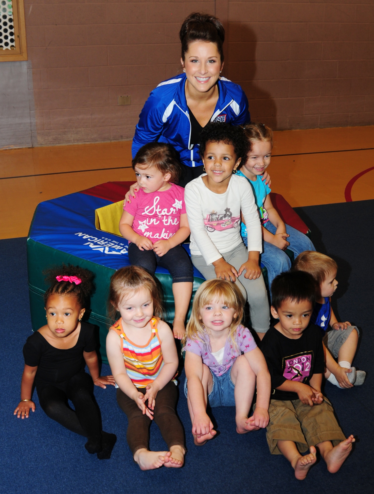 RAF MILDENHALL, England – Carly Patterson, gymnast and Olympic gold-medalist, poses with children from the toddlers’ gymnastics class at the RAF Mildenhall Youth Center Aug. 13, 2012. Patterson visited the base as part of a United Services Organization tour and took the time to visit the youth center and help with the class. (U.S. Air Force photo/Karen Abeyasekere)