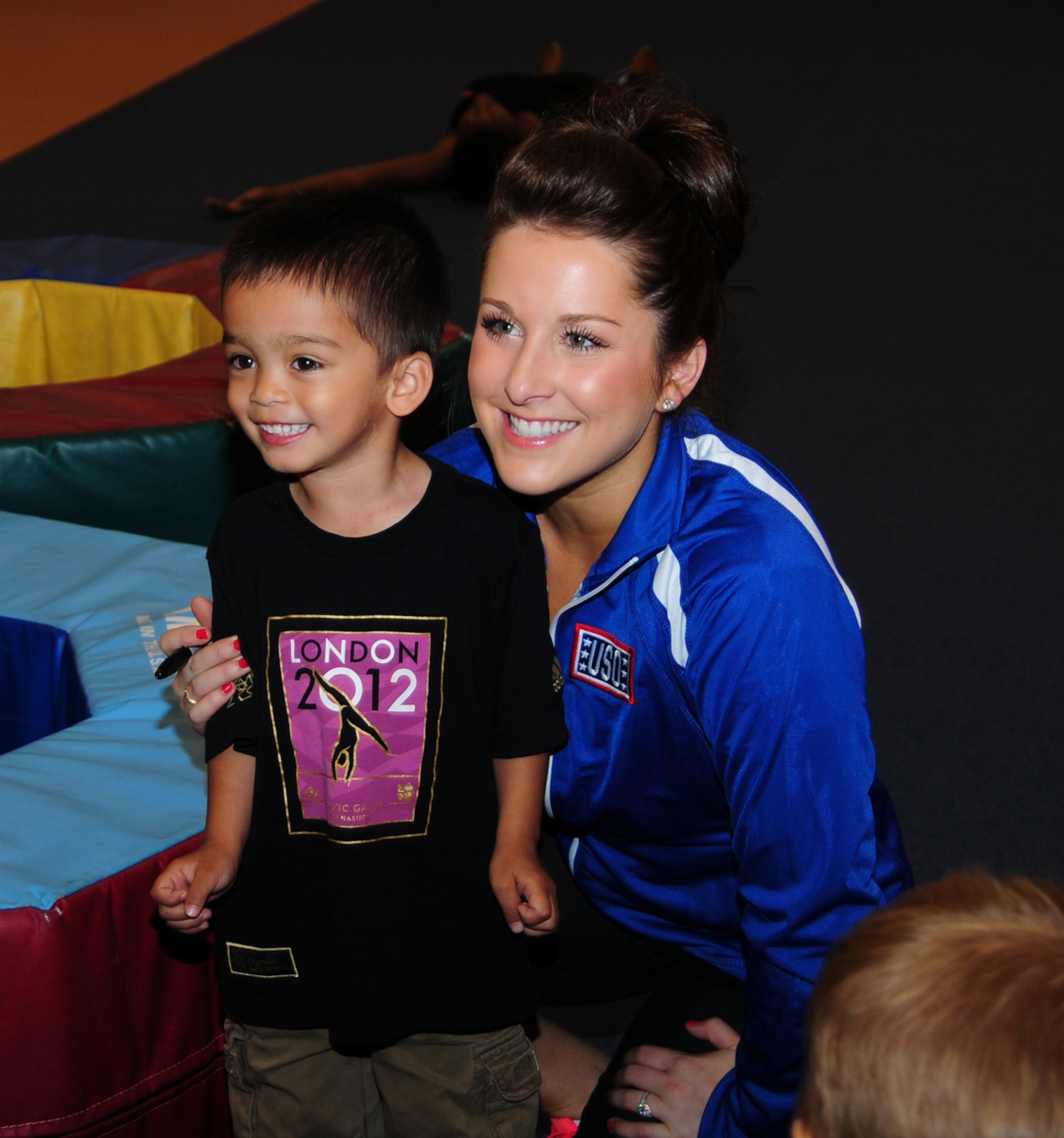 RAF MILDENHALL, England – Carly Patterson, gymnast and Olympic gold-medal winner and singer, poses for a photo with Enzo Deasis, 4, after a toddlers’ gymnastics class at the RAF Mildenhall Youth Center Aug. 13, 2012. During the visit, there was a meet-and-greet at the Base Exchange, where Patterson signed autographs. (U.S. Air Force photo/Karen Abeyasekere)