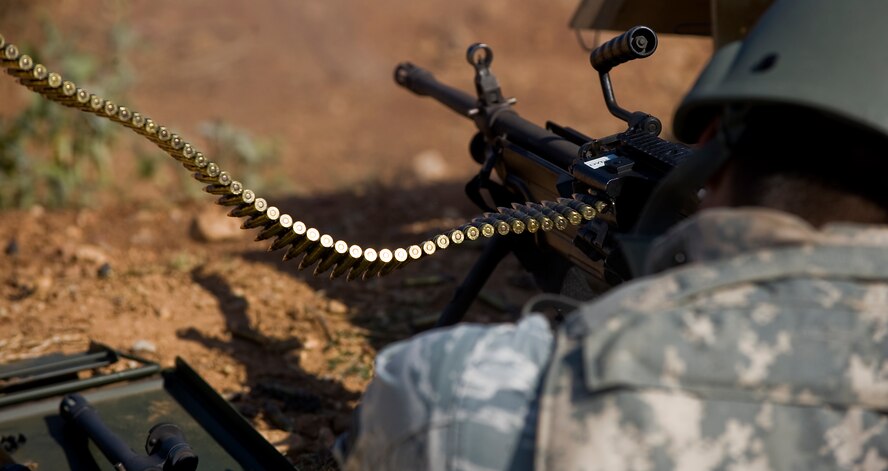 Senior Airman Nicholas Navarro, fires a M249 light machine gun Aug. 10, 2012, during a heavy-weapons qualification course at Camp Bowie, Texas. While at the firing range, Airmen shot a M249 light machine gun at targets ranging from 25 to 300 meters. The M249 allows servicemembers to place mass amount of fire on an enemy position, suppressing their movement. Prior to firing at the range, Airmen participate in a four-day classroom course, where they learn how to clean, disassemble, reassemble, operate, perform immediate actions and about different types of loads for the weapon.  (U.S. Air Force photo by Airman 1st Class Damon Kasberg/Released)