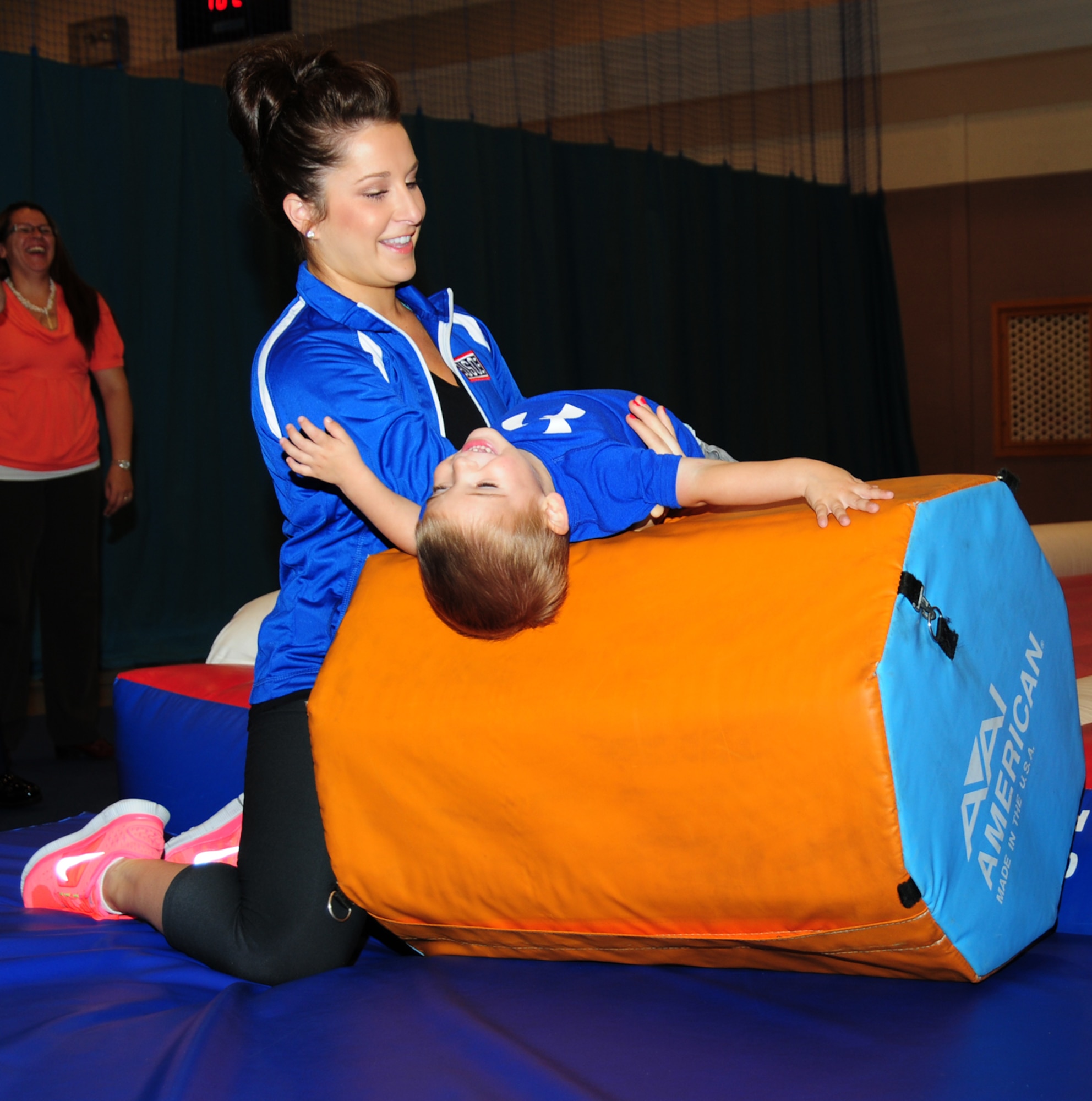 RAF MILDENHALL, England – Carly Patterson, gymnast and Olympic gold-medal winner, helps Christian Graham, 2, practice a backwards roll during a toddlers’ gymnastics class Aug. 13, 2012, at the RAF Mildenhall Youth Center. Patterson was 16 when she won her gold medal in Athens, Greece, in 2004. She visited the base as part of a United Services Organization tour. (U.S. Air Force photo/Karen Abeyasekere)