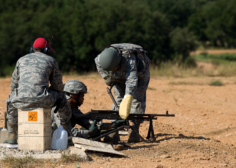 Airman 1st Class Jazmyn Muse, changes the barrel of a M240 machine gun Aug. 10, 2012, during a heavy-weapons qualification course at Camp Bowie, Texas. While at the firing range, Airmen assigned to the 7th Security Forces Squadron shot a M240 machine gun at targets ranging from 25 to 300 meters. The M240 allows servicemembers to place mass amount of fire on an enemy position, suppressing their movement. Prior to firing at the range, Airmen participate in a four-day classroom course, where they learn how to clean, disassemble, reassemble, operate, perform immediate actions and about different types of loads for the weapon.  (U.S. Air Force photo by Airman 1st Class Damon Kasberg/Released)