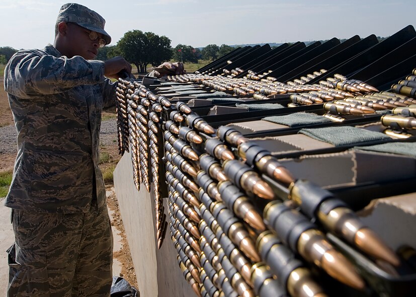 Airman 1st Class Raymond Thompkins, prepares ammo for a M240 machine gun Aug. 10, 2012, during a heavy-weapons qualification course at Camp Bowie, Texas. While at the firing range, Airmen assigned to the 7th Security Forces Squadron shot a M240 machine gun at targets ranging from 25 to 300 meters. The M240 allows servicemembers to place mass amount of fire on an enemy position, suppressing their movement. Prior to firing at the range, Airmen participate in a four-day classroom course, where they learn how to clean, disassemble, reassemble, operate, perform immediate actions and about different types of loads for the weapon.  (U.S. Air Force photo by Airman 1st Class Damon Kasberg/Released)