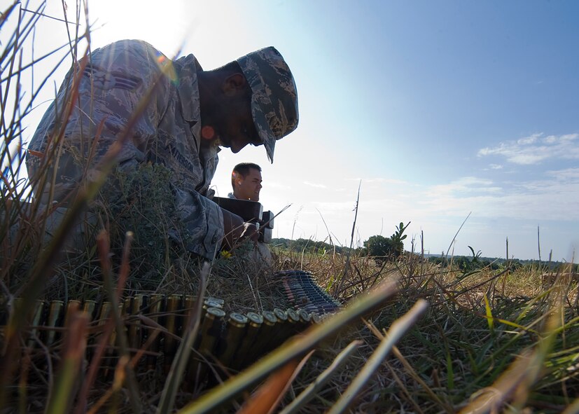 Senior Airman Alexi Patterson, prepares ammo for a M249 light machine gun Aug. 10, 2012, during a heavy-weapons qualification course at Camp Bowie, Texas. While at the firing range, Airmen assigned to the 7th Security Forces Squadron shot a M249 light machine gun at targets ranging from 25 to 300 meters. The M249 allows servicemembers to place mass amount of fire on an enemy position, suppressing their movement. Prior to firing at the range, Airmen participates in a four-day classroom course, where they learn how to clean, disassemble, reassemble, operate, perform immediate actions and about different types of loads for the weapon.  (U.S. Air Force photo by Airman 1st Class Damon Kasberg/Released)