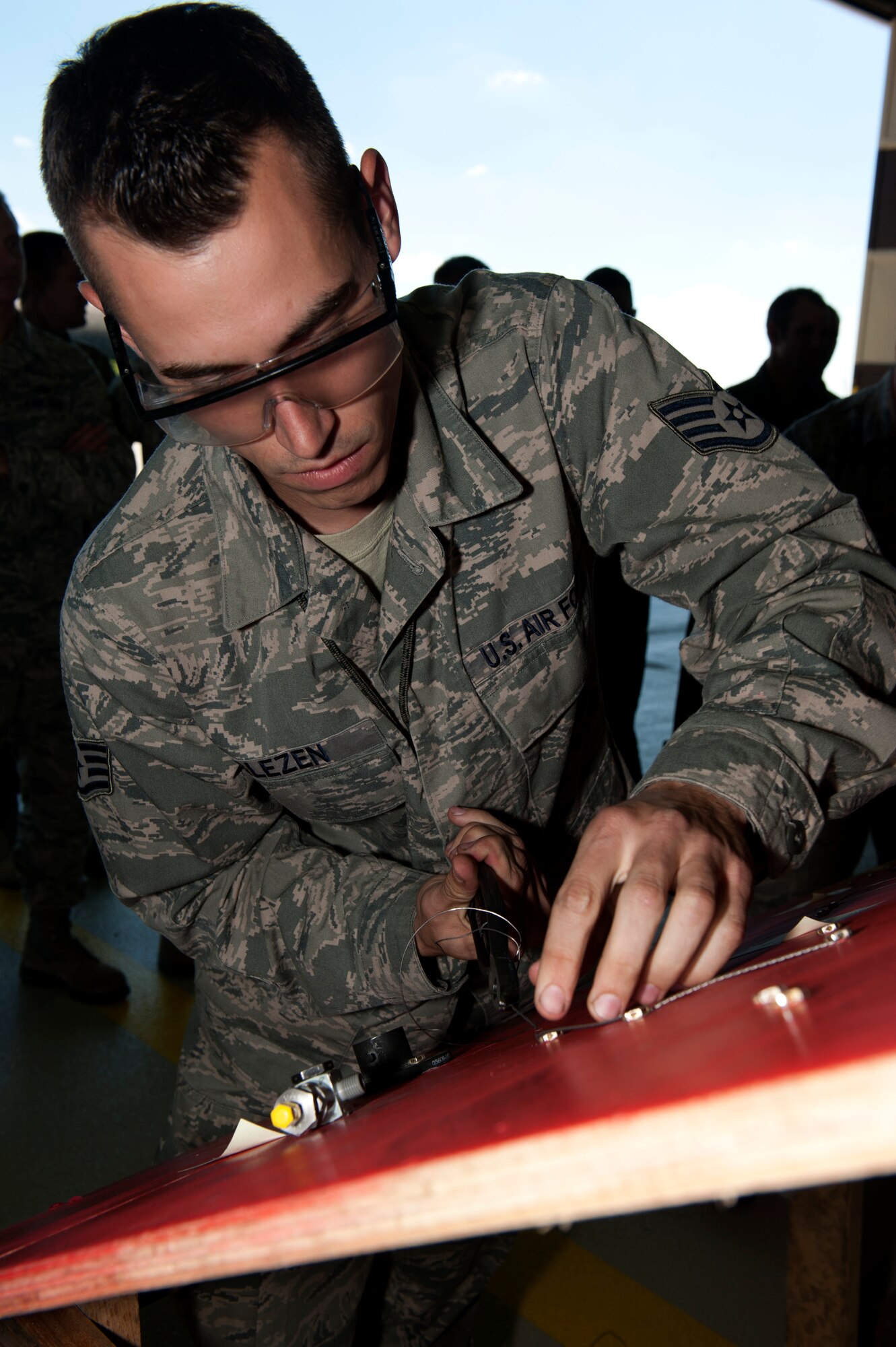 SPANGDAHLEM AIR BASE, Germany – Staff Sgt. Corey Glezen, 480th Aircraft Maintenance Unit crew chief, connects bolts together using safety wire as part of a crew chief competition here Aug. 10.  The safety wire board is used for training purposes and simulates the work maintainers may need to perform on aircraft safety wires.  A select few crew chiefs from the 480th and 81st AMUs undergo a series of mental and physical trials to test their skills and knowledge during the competition.  The winners earn bragging rights as the best maintenance unit until the next competition and also take home a wooden toolbox inscribed with the crew chief’s creed as a trophy. (U.S. Air Force photo by Airman 1st Class Gustavo Castillo/Released)