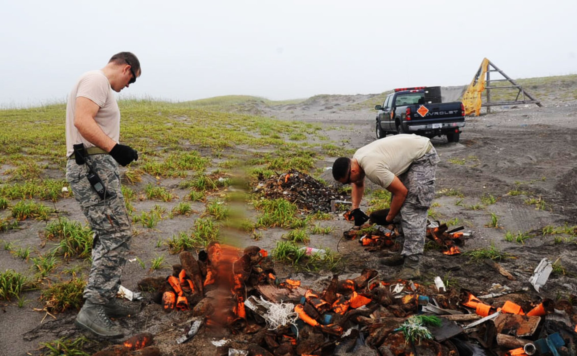U.S. Air Force Tech. Sgt. Kristopher Parker, left, 35th Civil Engineer Squadron explosive ordnance disposal NCO in charge of EOD operations, and Senior Airman William Holliday, 35 CES EOD technician, sorts through dud explosives at Draughon Range in Misawa, Japan, Aug. 13, 2012. EOD Airmen specialize in explosives and are the only Airmen permitted to touch explosive ordnances. (U.S. Air Force photo by Airman 1st Class Kenna Jackson/Released)