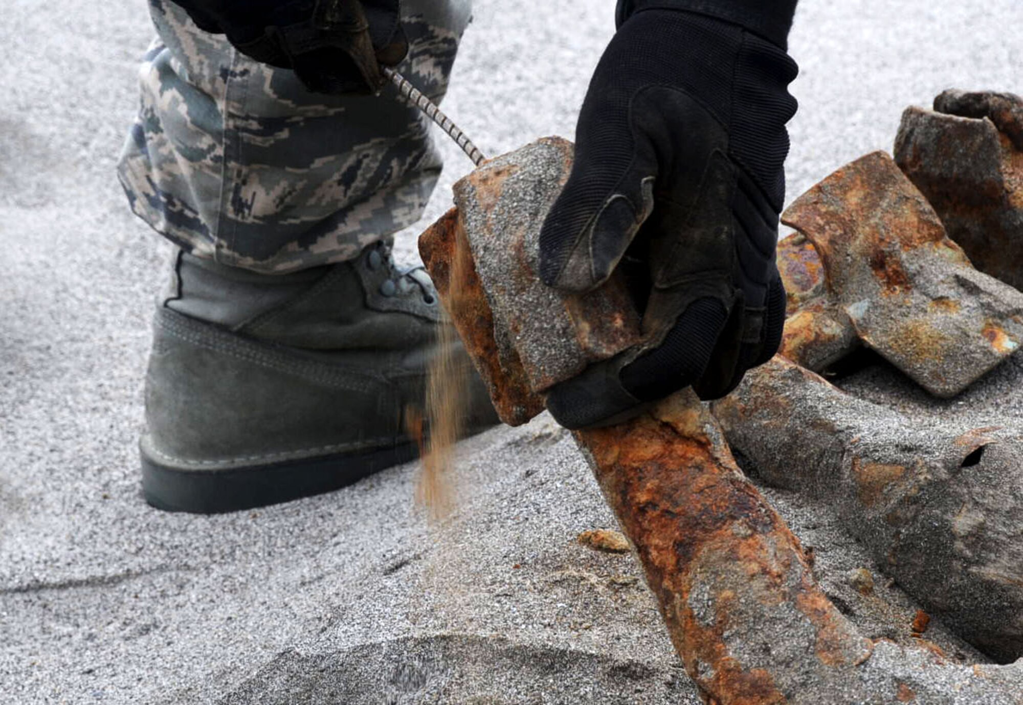 A U.S. Air Force 35th Civil Engineer Squadron explosive ordnance disposal Airman probes a dud explosive at Draughon Range in Misawa, Japan, Aug. 13, 2012. EOD Airmen probe explosives to find out if it’s a dud or not. (U.S. Air Force photo by Airman 1st Class Kenna Jackson/Released)