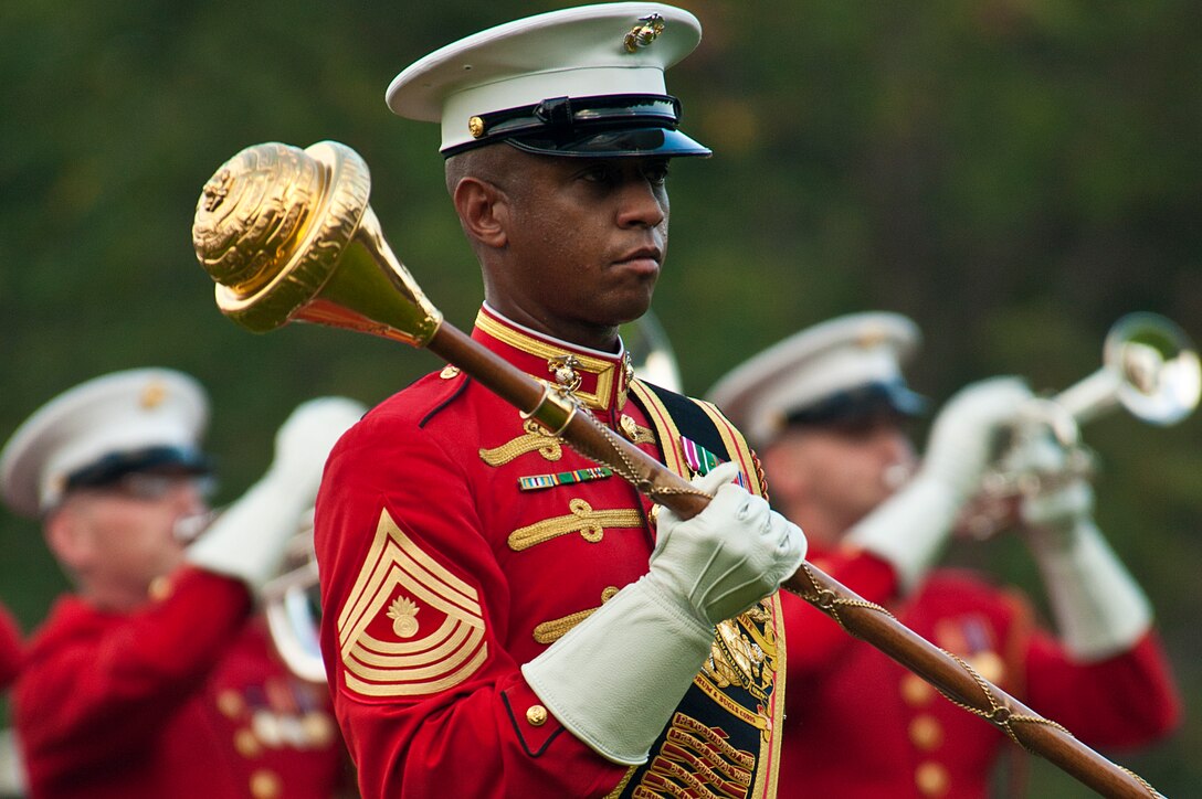 Master Gunnery Sgt. Kevin Buckles, Marine Drum & Bugle Corps drum major, directs his musicians during a Tuesday Sunset Parade at the Marine Corps War Memorial in Arlington, Va., Aug. 14.