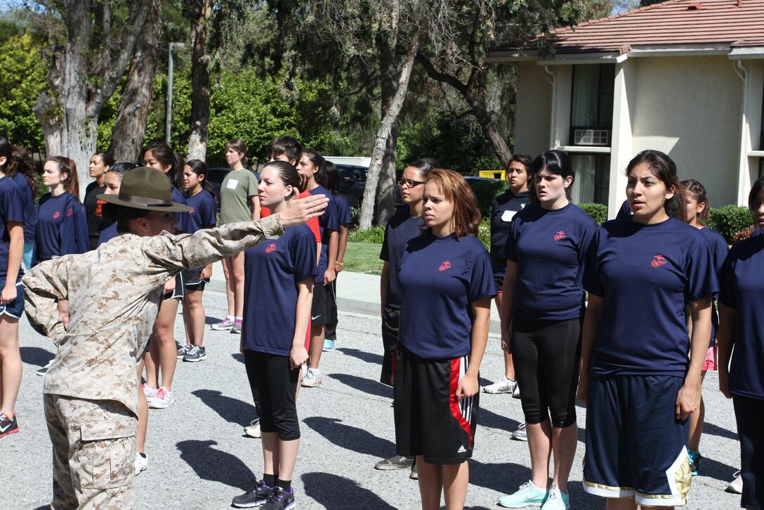 Drill Instructor Sgt. Rebecca Jones, 4th Recruit Training Battalion, Marine Corps Recruit Depot Parris Island, corrects a poolee at the Female Poolee Function here March 28. Poolees learned about recruit training, drill and ceremony and Marine Corps knowledge at the event