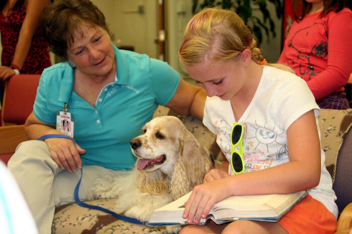 Children of all ages were encouraged to participate in the "Ruff" Readers program held at the library Aug. 8 aboard Marine Corps Recruit Depot San Diego. Program educates children on the importance of being a pet owner and encourages children to be active readers. The dogs came from Independent Therapy Dogs, Inc. and were escorted by their handlers Margaret Klingensmith and Shirley Colman, founder of ITD, Inc.