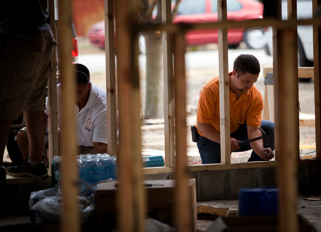 Paul McCully, F.A. Wilhelm Construction, hammered nails into a garage during a house-building project for wounded Marine Sgt. Jesse James on July 26th, 2012. Kelly volunteered to help reserve Marines from the Homes for Wounded Warriors Program build James a wood-shop prior to his return from military service.