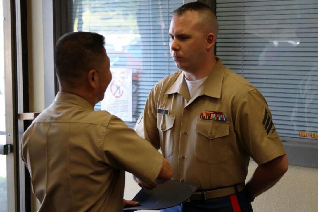 Brig. Gen Yoo presents a meritorious mast to Sgt. Sean Leger, a recruiter with RSS Bremerton, on April 23-24. Members of the Western Recruiting Region command staff came to the RS Seattle area of operations to speak with Marines and tour the area.