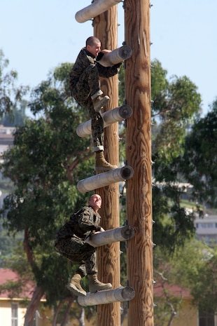 Recruits of Company M, 3rd Recruit Training Battalion, race to the top of the Stairway to Heaven obstacle Aug. 14 aboard Marine Corps Recruit Depot San Diego. The Stairway to Heaven is a ladder like structure that has evenly spaced logs that recruits are required to climb up. Through completing this obstacle, recruits can face their fear of height and gain confidence.