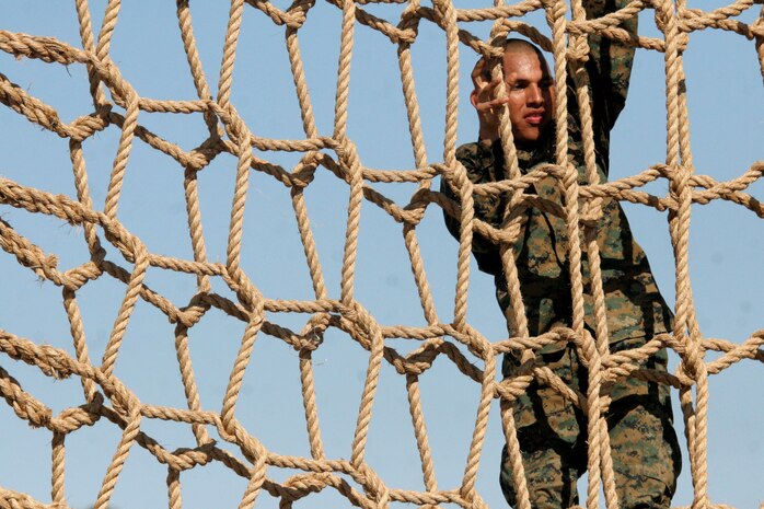 A recruit begins to climb down the other side of an obstalce during the Confidence Course Aug. 14 aboard Marine Corps Recruit Depot San Diego. Each obstacle at the Confidence Course challenges recruits both physically and mentally by pushing them to their limits and having them face any fear of an obstacle.