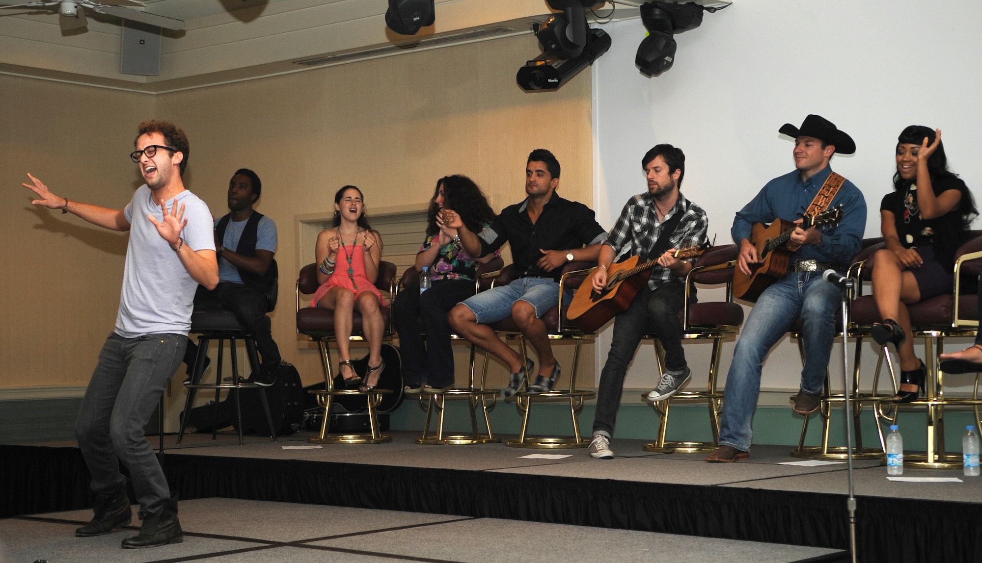 Singers with the “Idols World Tour” entertain the audience at Kunsan Air Base, Republic of Korea, Aug. 15, 2012. More than 100 Airmen showed up to hear the acoustic performances. (U.S. Air Force photo/Senior Airman Brigitte N. Brantley)