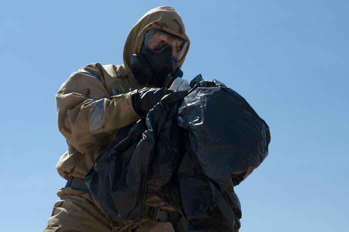 A U.S. Air Force Airborne Explosive Ordnance Disposal Airman assigned to the 820th  RED HORSE prepares to clean and remove an unexploded ordnance during a training exercise Aug. 14, 2012, at Nellis Air Force Base, Nev. This training exercise was conducted as part of upgrade training for the EOD Airmen. (U.S. Air Force photo by Airman 1st Class Christopher Tam)