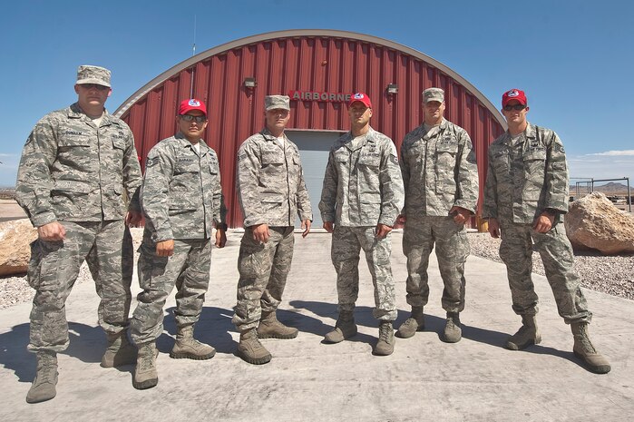 U.S. Air Force explosive ordnance disposal team members of the 820th  RED HORSE airborne flight, pose for a group photo Aug. 10, 2012, at Nellis Air Force Base, Nev. Airborne EOD members are trained and qualified to conduct operations in austere locations. Airmen featured not wearing RED HORSE designation caps are new squadron members who have not inprocessed the unit. (U.S. Air Force photo by Staff Sgt. Christopher Hubenthal)