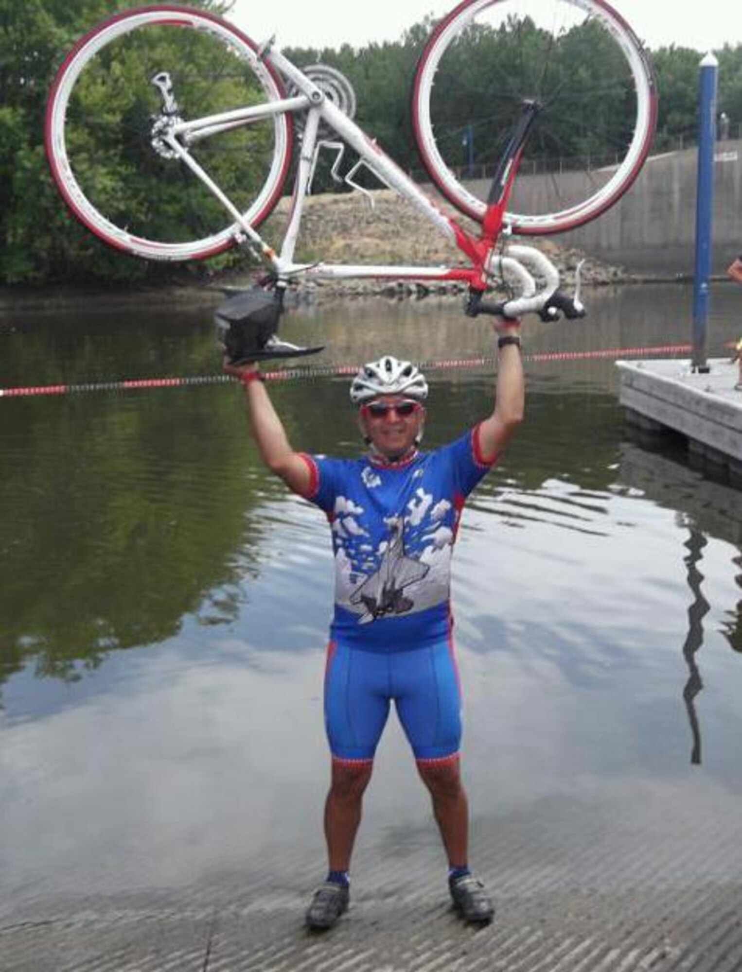 Senior Master Sgt. Julio A. Flores takes a winning stance with his bicycle above his head at the 40th Register's Annual Great Bicycle Ride Across Iowa. Known as RAGBRAI, it's the oldest, largest, and longest bicycling touring event in the world. (U.S. Air Force photo)
