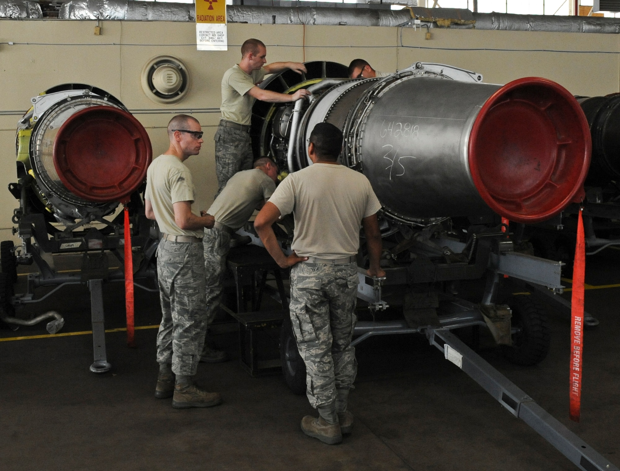 Airmen from the 2nd Maintenance Squadron Propulsion Flight work on a TF33/P-103 turbofan engine on Barksdale Air Force Base, La., Aug. 13. The engine was shipped from the Maintenance Depot at Tinker AFB, Okla., where all TF33/P-103 turbofan engines go for scheduled and major maintenance. The B-52H Stratofortress uses eight TF33/P-103 turbofan engines, each capable of producing 17,000 pounds of thrust.  (U.S. Air Force photo/Airman 1st Class Micaiah Anthony)(RELEASED)