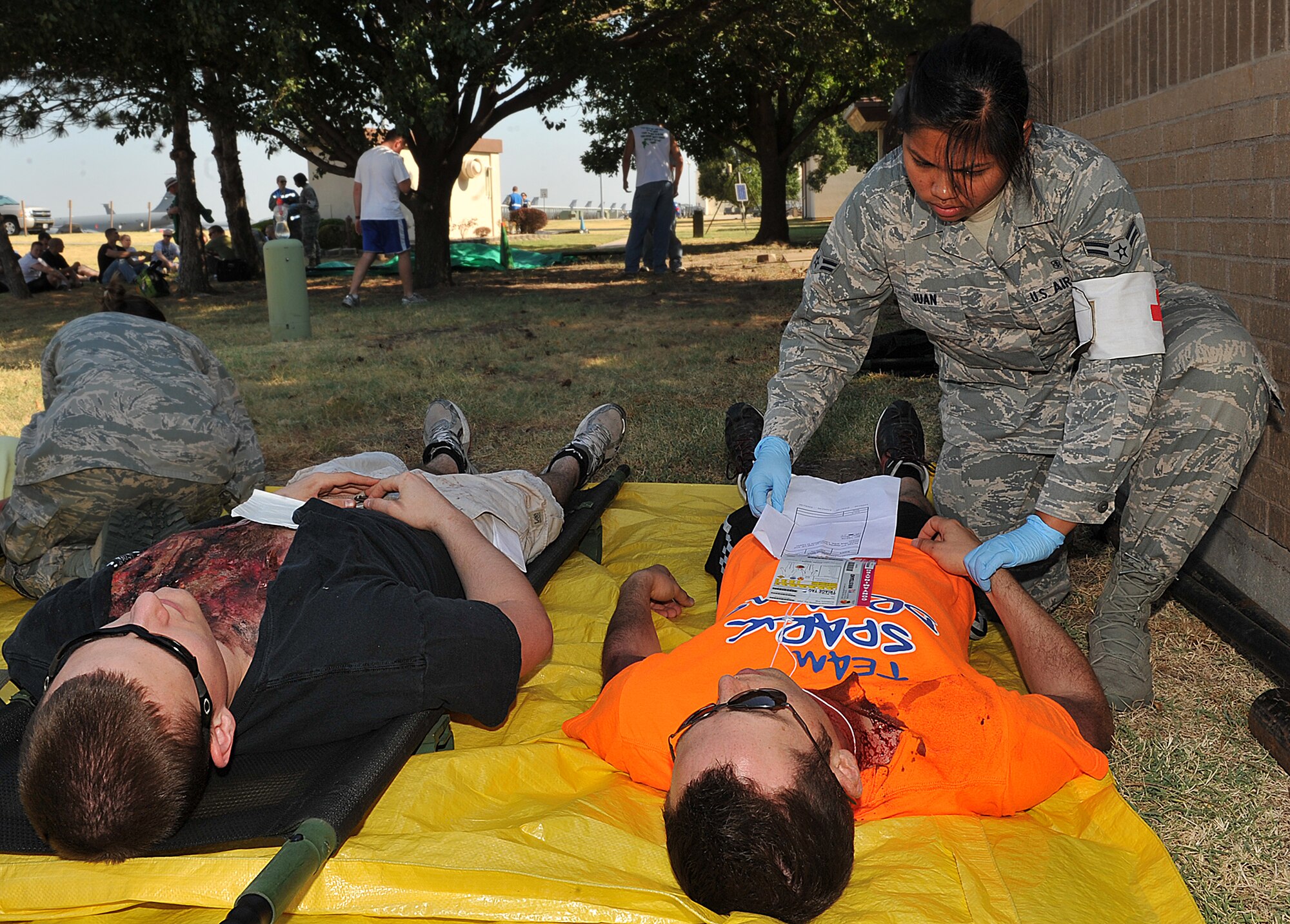 Airman 1st Class Noemi Juan, 22nd Medical Group medical technician, treats Senior Airman Lawrence Seay, 22nd Medical Group bio medical equipment technician, for a simulated second degree chest burn during a major accident response exercise Aug. 15, 2012 McConnell Air Force Base, Kan. During the MARE scenario, Airman responded to “victims” who were in a simulated plane crash. (U.S. Air Force photo/Airman 1st Class Maurice A. Hodges)