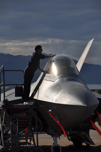 Tech. Sgt. Bobby Breher, 477th Aircraft Maintenance Squadron dedicated crew chief, cleans the canopy of an F-22 during Combat Hammer, a weapons system evaluation program, at Hill AFB.  (U.S. Air Force Photo/Tech. Sgt. Dana Rosso)