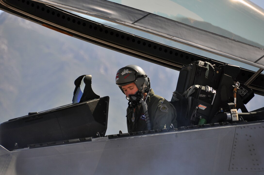 Lt. Col. Chad Feucht, a Reserve F-22 pilot assigned to the 477th Fighter Group, conducts final checks on his flight equipment Aug. 4. Feucht, along with active duty and Air National Guard F-22 pilots participated in a Combat Hammer exercise. During the exercise Alaska F-22 Raptors became the first operational F-22 unit to drop GBU-39 small diameter bombs. (U.S. Air Force Photo/Tech. Sgt. Dana Rosso)