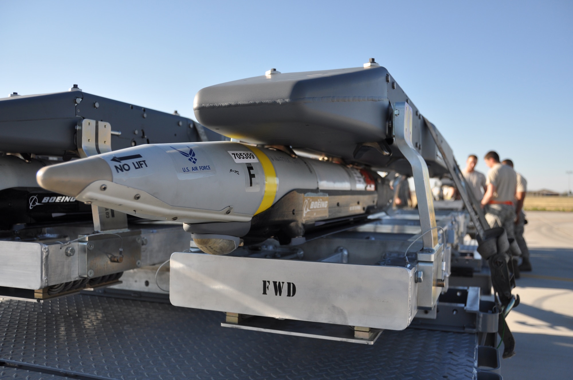 Members of the 3rd Wing and the 477th Fighter Group prepare to load a GBU-39 on to an F-22 during Combat Hammer at Hill AFB. The GBU-39 is a 250-pound precision-guided glide bomb that is intended to provide aircraft with the ability to carry a higher number of bombs. (U.S. Air Force Photo/Tech. Sgt. Dana Rosso)

