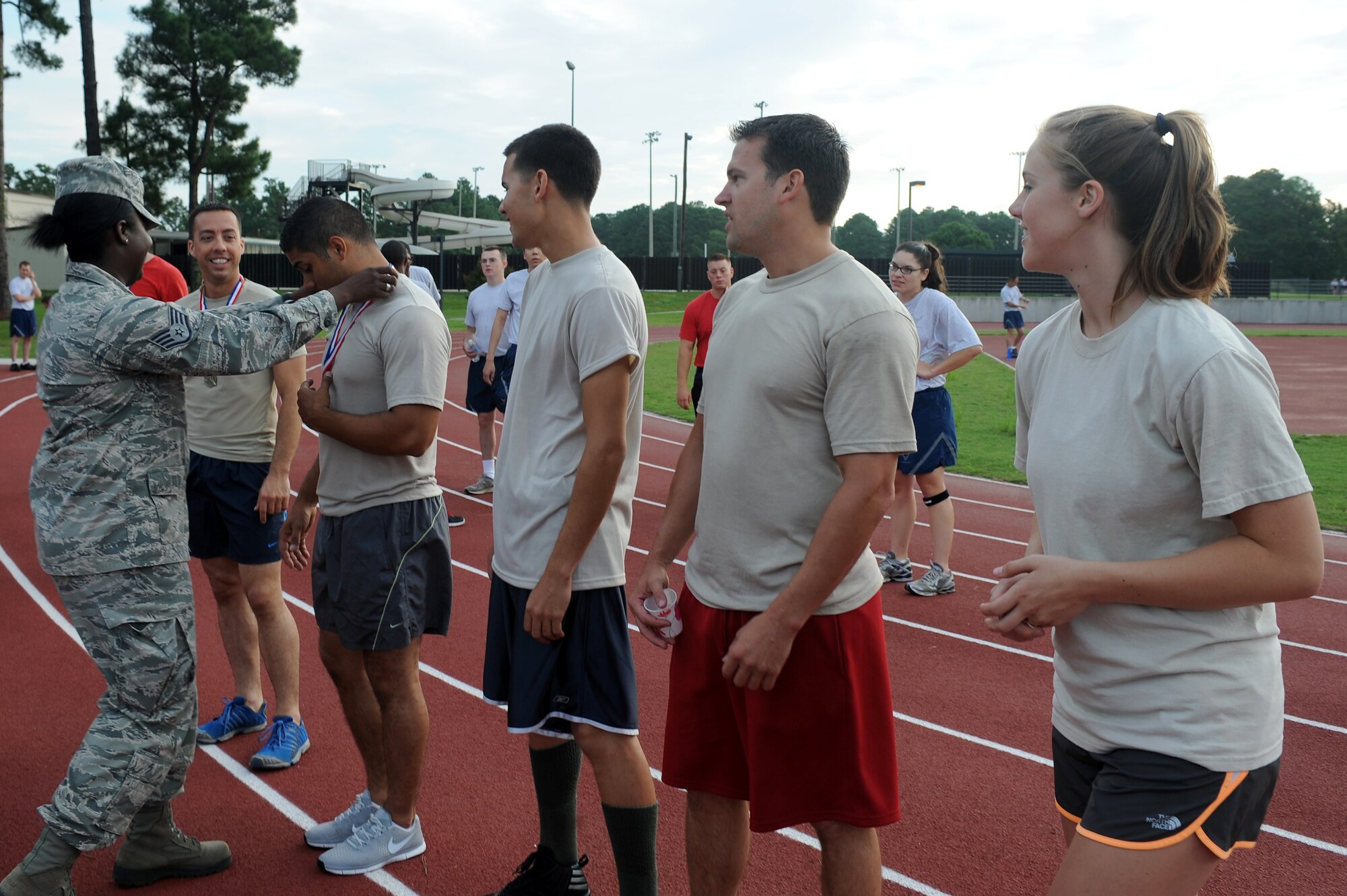 Members of the 482nd Aircraft Maintenance Squadron team are awarded 1st place medals after finishing the Beat the Heat relay run at Seymour Johnson Air Force Base, N.C., Aug. 10, 2012. The 482nd AMXS team finished with a run time of 5:27. (U.S. Air Force photo/Airman 1st Class John Nieves Camacho/Released)