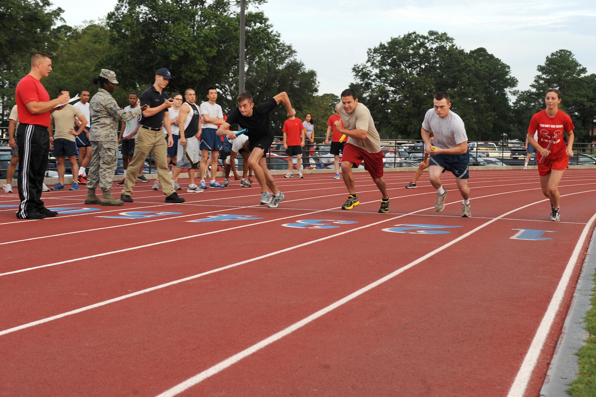 Participants competing in the Beat the Heat relay run take off from the starting line of the race at Seymour Johnson Air Force Base, N.C., Aug. 10, 2012. The 482nd Aircraft Maintenance Squadron, 4th Equipment Maintenance Squadron, 4th Logistics Readiness Squadron and 4th Force Support Squadron fielded teams for the event. (U.S. Air Force photo/Airman 1st Class John Nieves Camacho/Released)