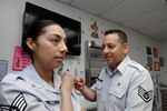 Staff Sgt. Caroline Mejia, 359th Medical Group, receives an immunization from Staff Sgt. Alex FarFan, 359th Medical Group allergy immunization technician, at the Joint Base San Antonio-Randolph Clinic April 2. (U.S. Air Force photo by Don Lindsey)
