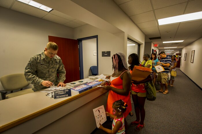 Children and their parents go through a deployment line during the Children's Deployment Camp, Aug. 14, 2012, at Joint Base Charleston – Air Base, S.C. The Children’s Deployment Camp, hosted by the Airman and Family Readiness Center, offered children, age five to 14 whose parents have recently returned from deployment, are currently deployed or are scheduled to deploy within the next six months, the opportunity to experience many of the same things their parents have to go through to prepare for a deployment. (U.S. Air Force photo by Airman 1st Class George Goslin)