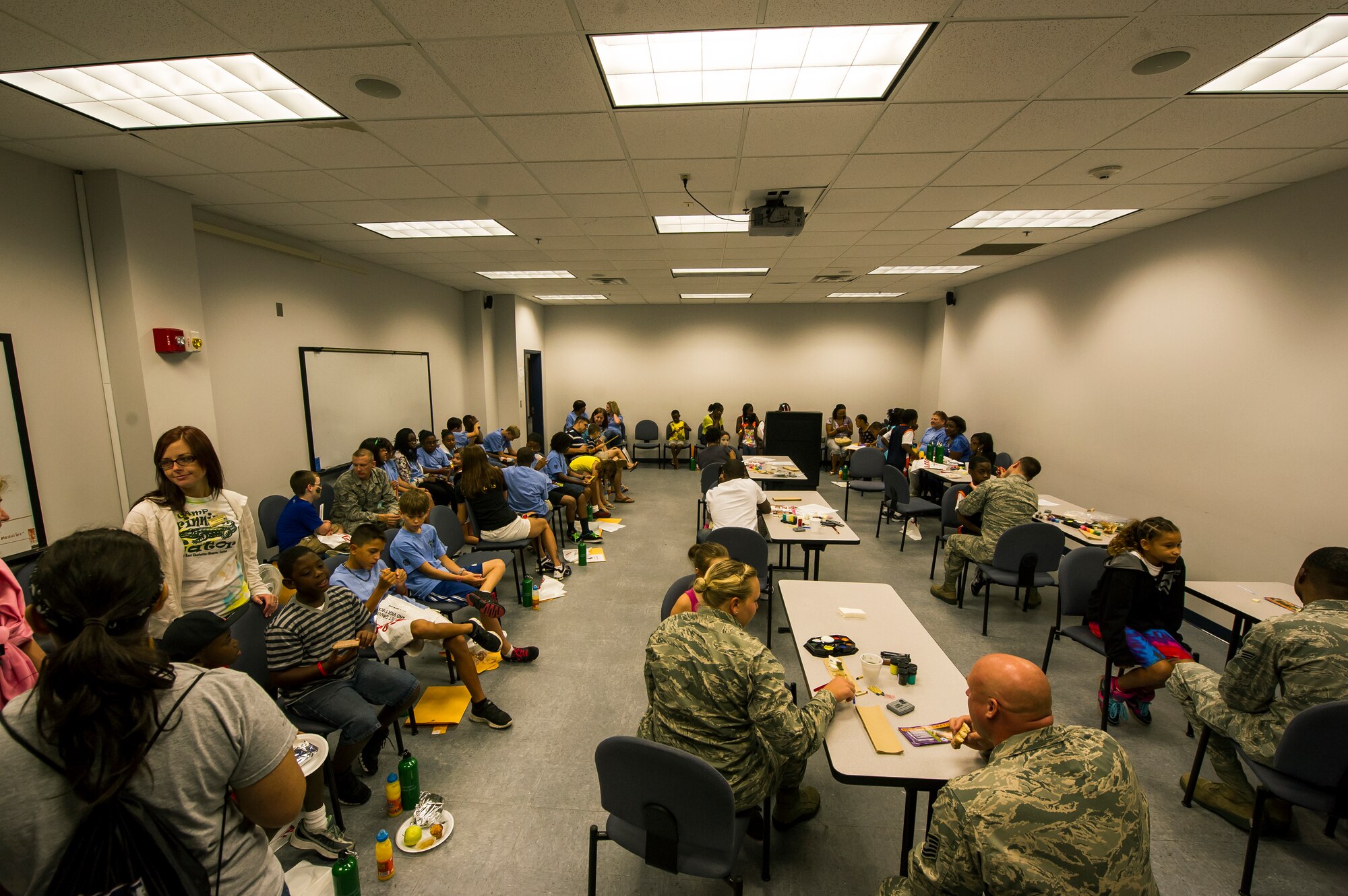 Children participating in the Children's Deployment Camp get their face painted and speak to volunteers, Aug. 14, 2012, at Joint Base Charleston - Air Base, S.C. The Children’s Deployment Camp, hosted by the Airman and Family Readiness Center, offered children, age five to 14 whose parents have recently returned from deployment, are currently deployed or are scheduled to deploy within the next six months, the opportunity to experience many of the same things their parents have to go through to prepare for a deployment. (U.S. Air Force photo by Airman 1st Class George Goslin)